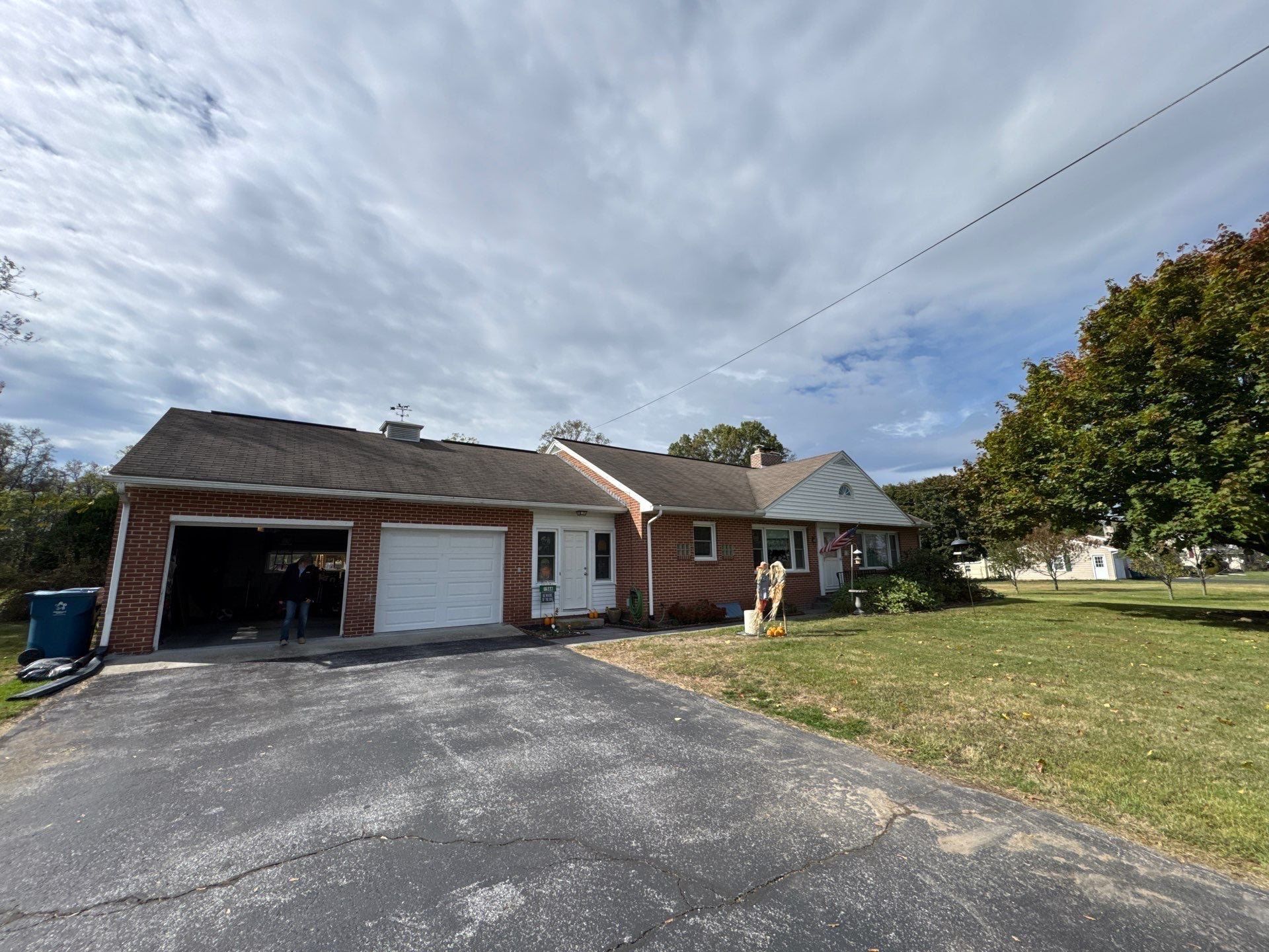 Single-story brick home on Baltimore Road in Dillsburg, PA with an asphalt shingle roof prepared for a complete roof replacement.