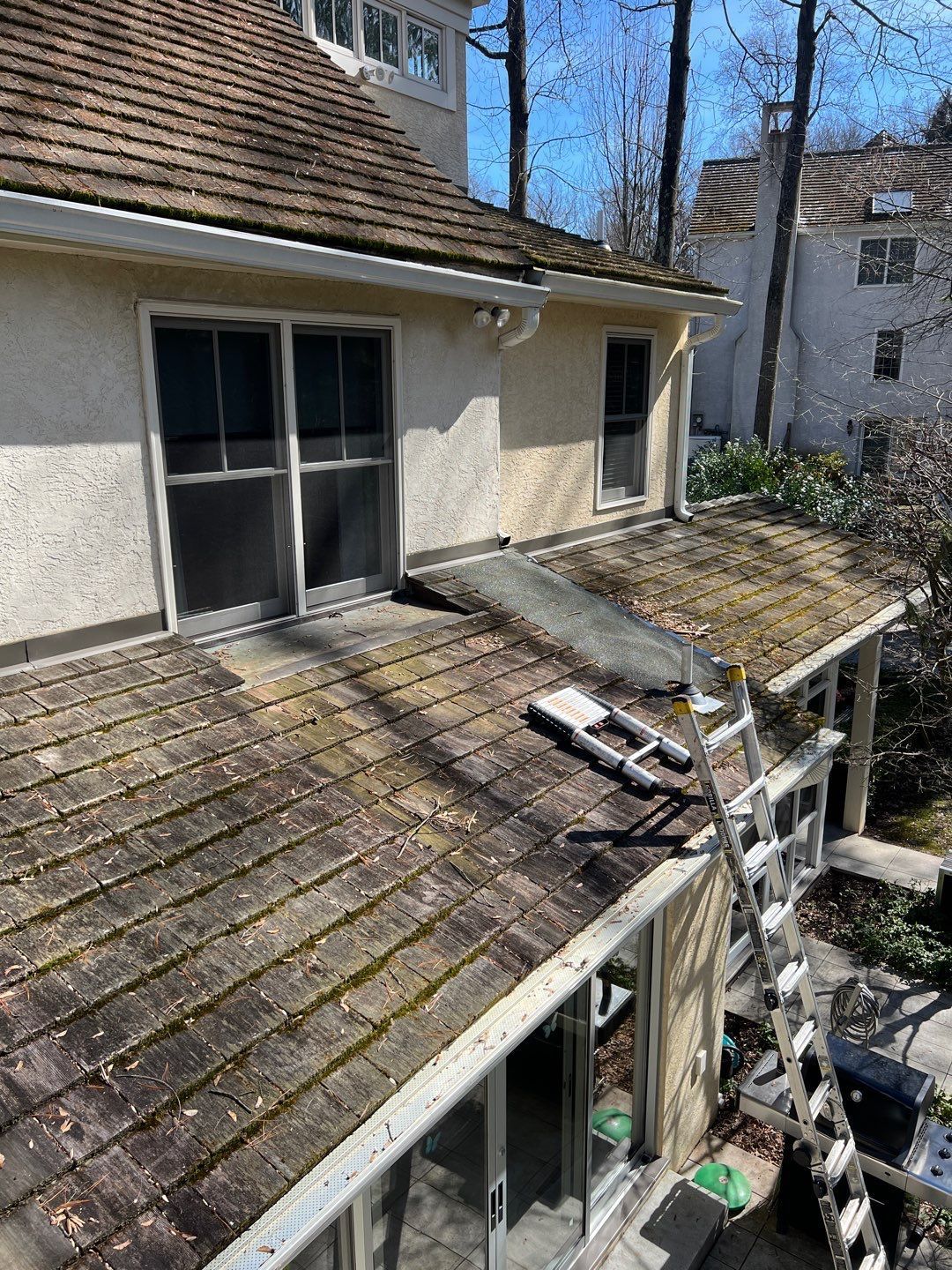 Aging wood shingle roof with moss growth on Biches Lane in Bryn Mawr, PA