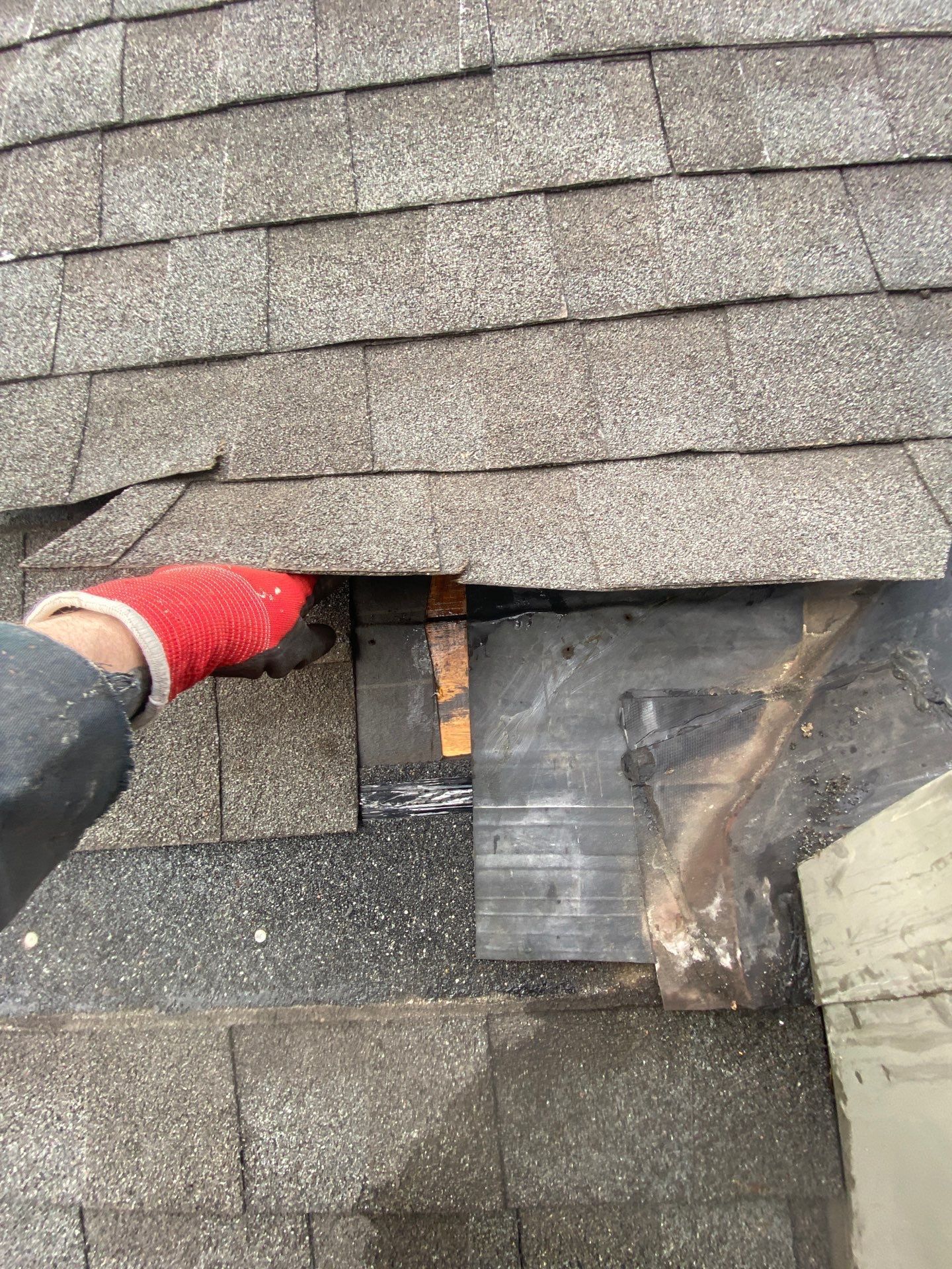 Damaged chimney flashing and deteriorated roof decking discovered during a roof replacement on York Street in Hanover, PA.