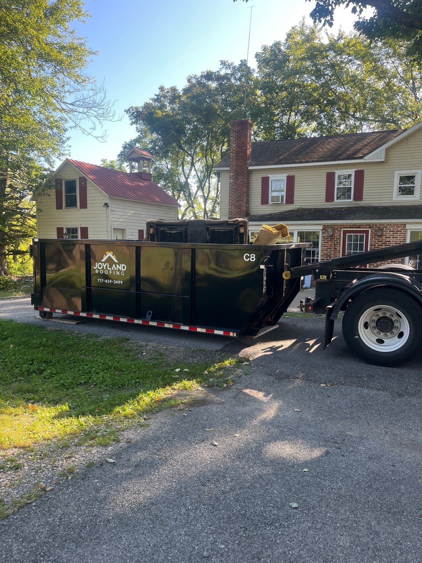 Joyland Roofing dumpster delivered for a roof replacement project on East Cabin Hollow Road in Dillsburg, PA.
