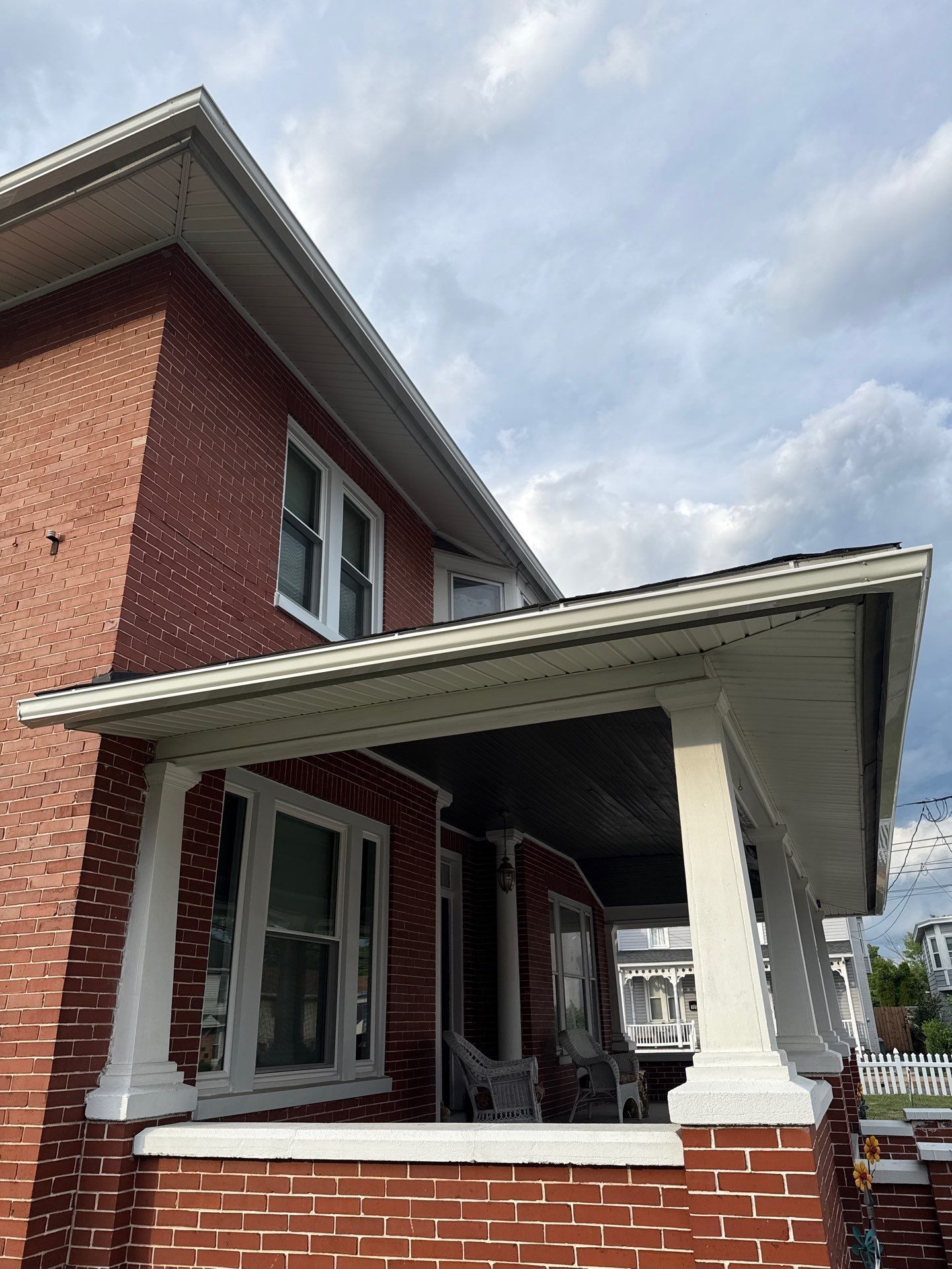 Completed asphalt shingle roof replacement and gutter system installation on a historic brick home along Hummelstown Street in Elizabethtown, PA.