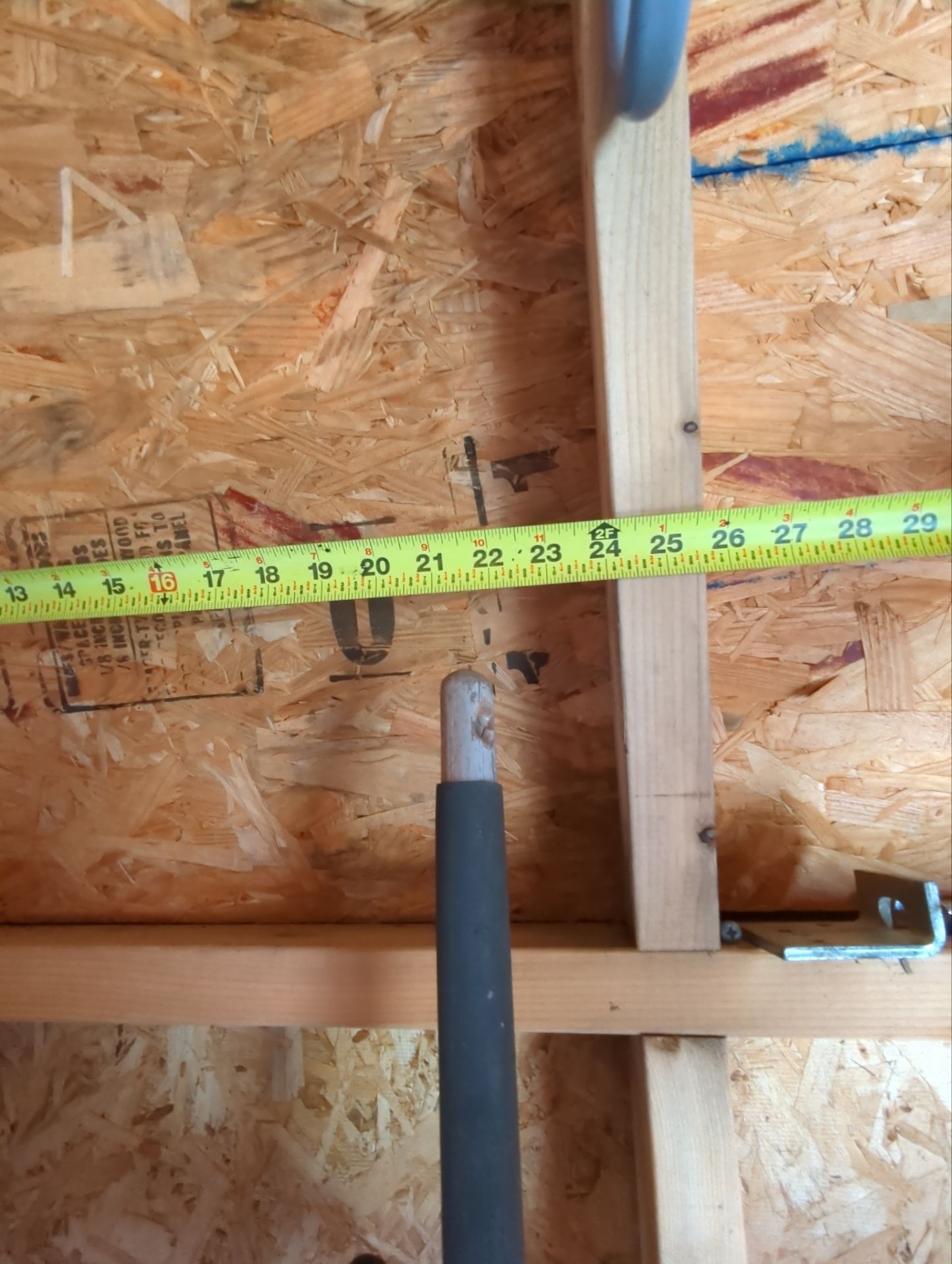 Roof replacement inspection on Brentwood Drive in Willow Grove, PA showing roof framing and sheathing with a tape measure documenting construction dimensions