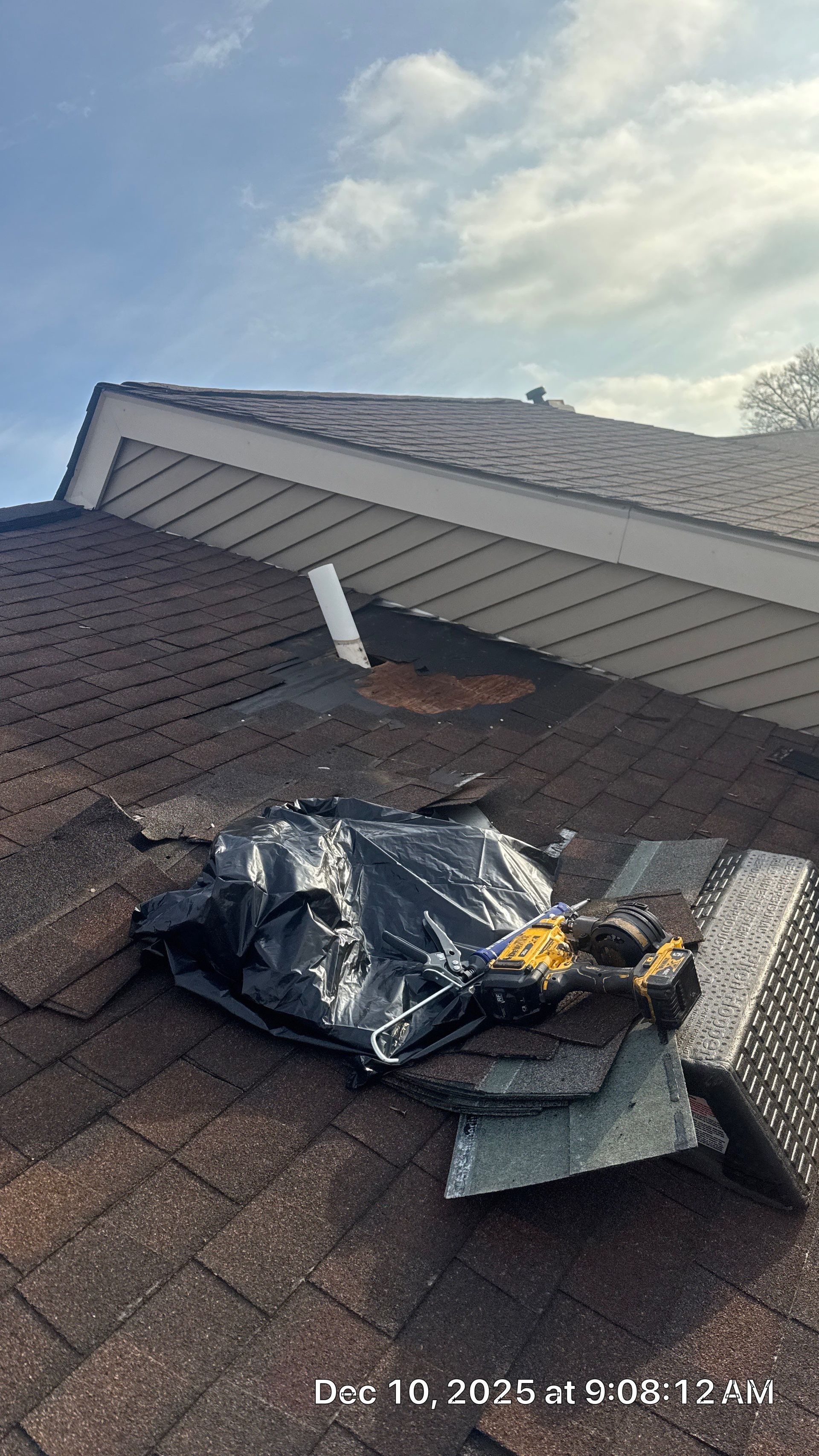 Roof replacement project in progress on Keats Court in Lansdale, PA, showing damaged shingles being removed and new roofing materials prepared for installation