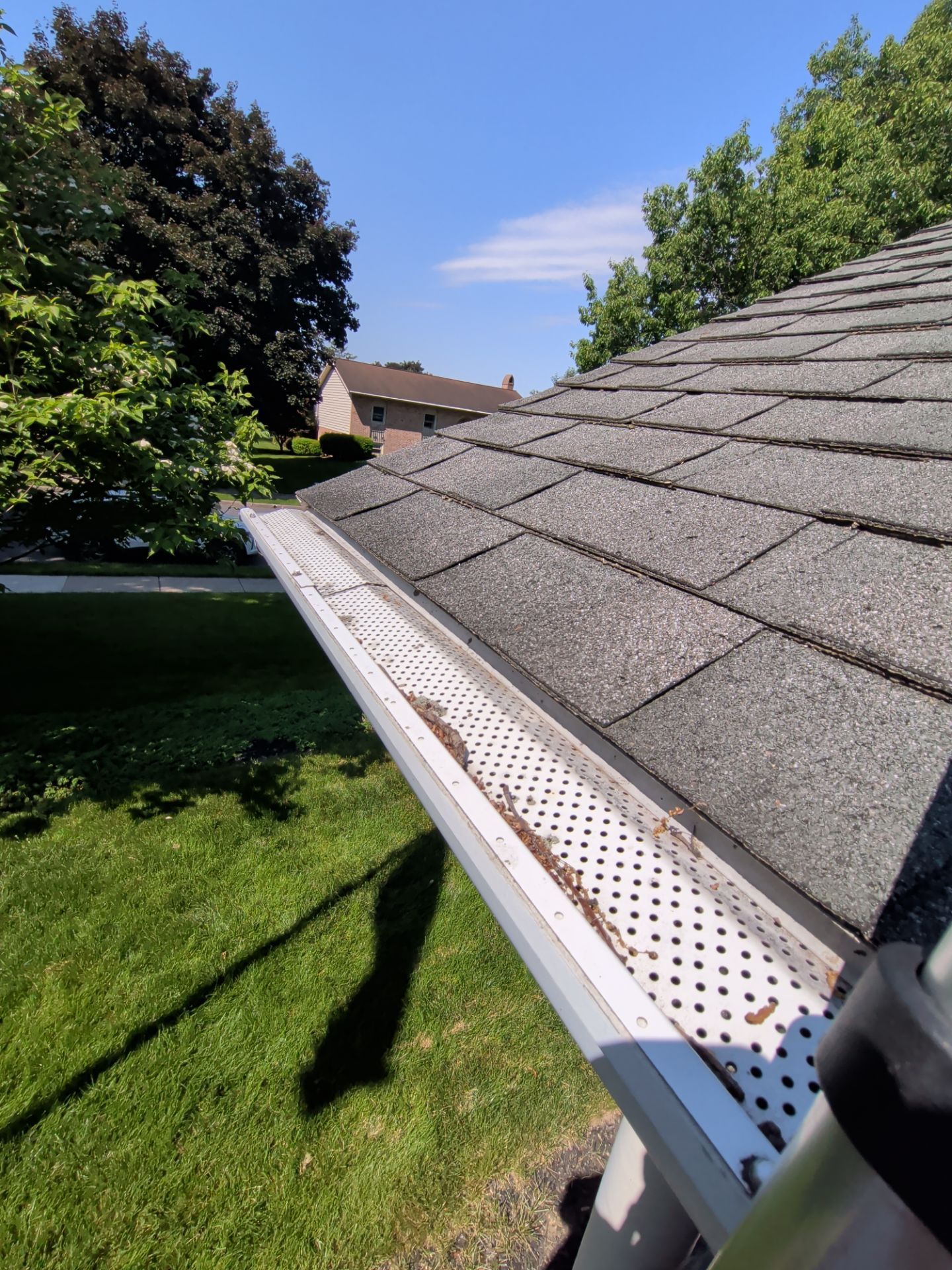 New roof replacement and gutter protection system installed on Lincoln Heights Avenue in Ephrata, PA featuring architectural shingles and gutter guards.