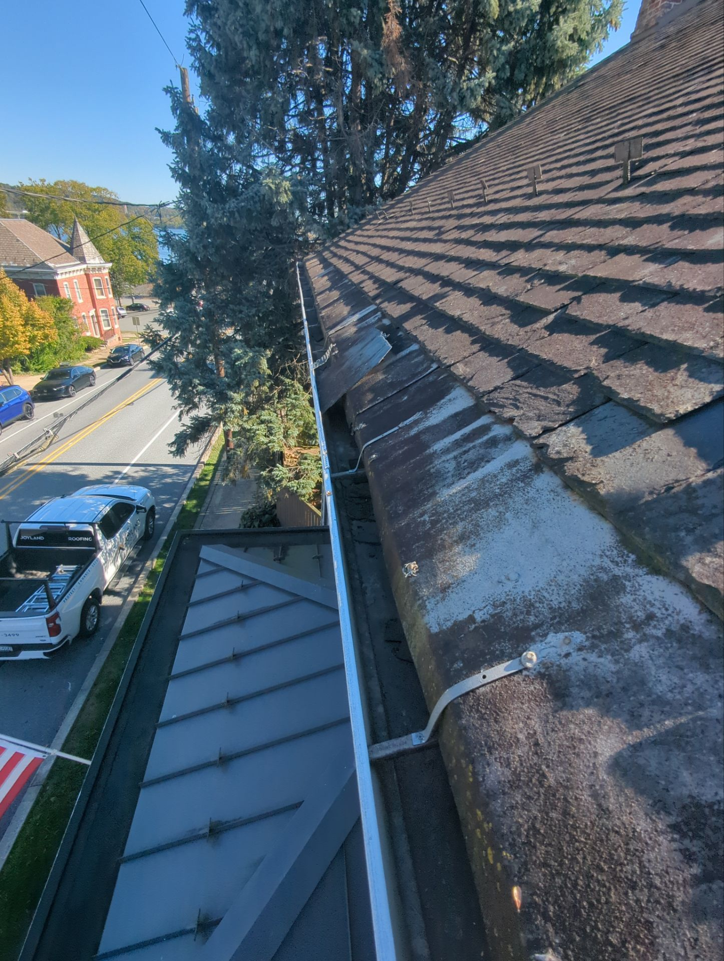Roof replacement project with new standing seam metal roofing and asphalt shingles on a home in Wrightsville, PA.