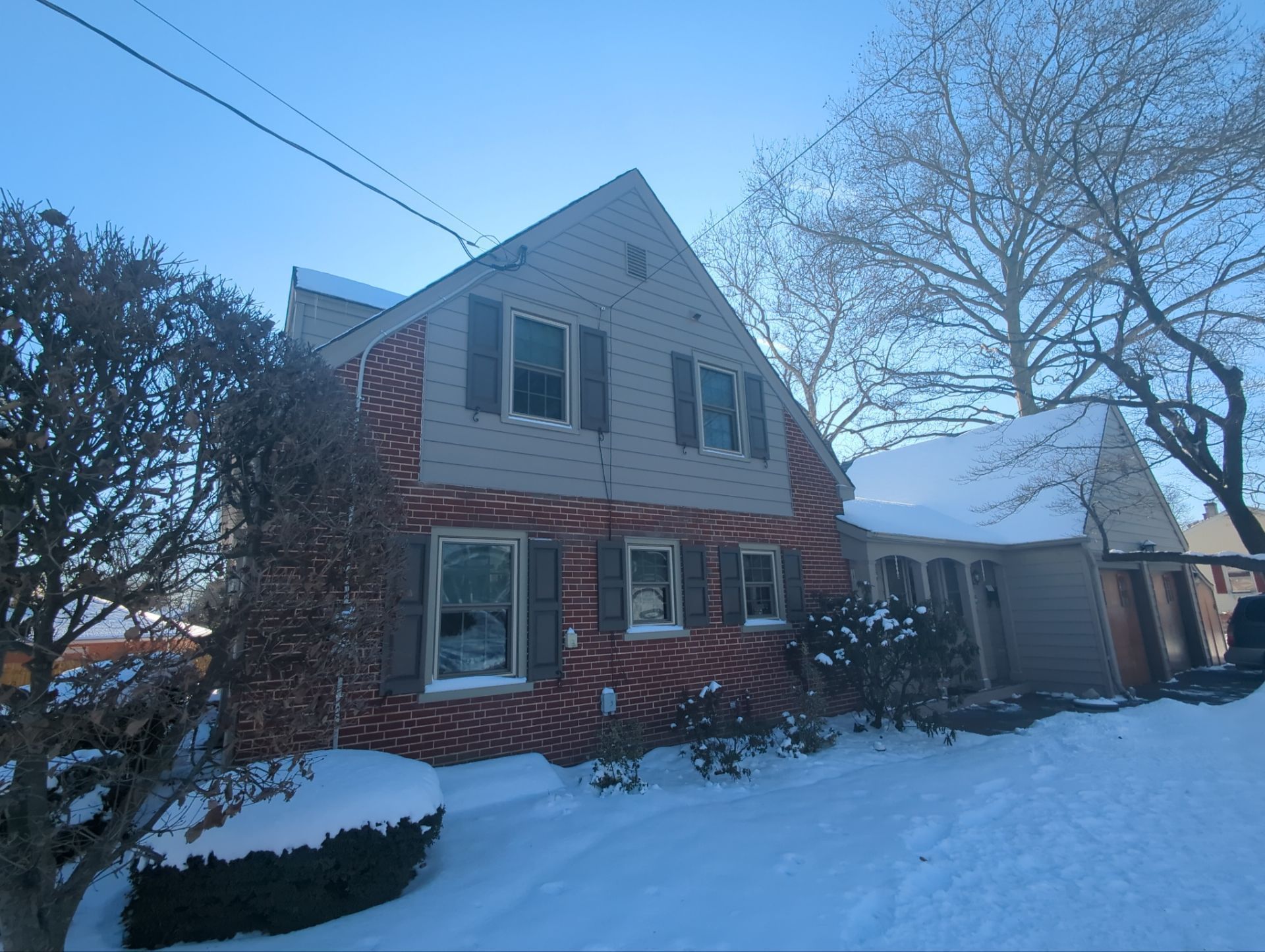 Residential roof replacement project on Main Street in East Petersburg, PA featuring a brick home protected with a new asphalt shingle roofing system during winter conditions.