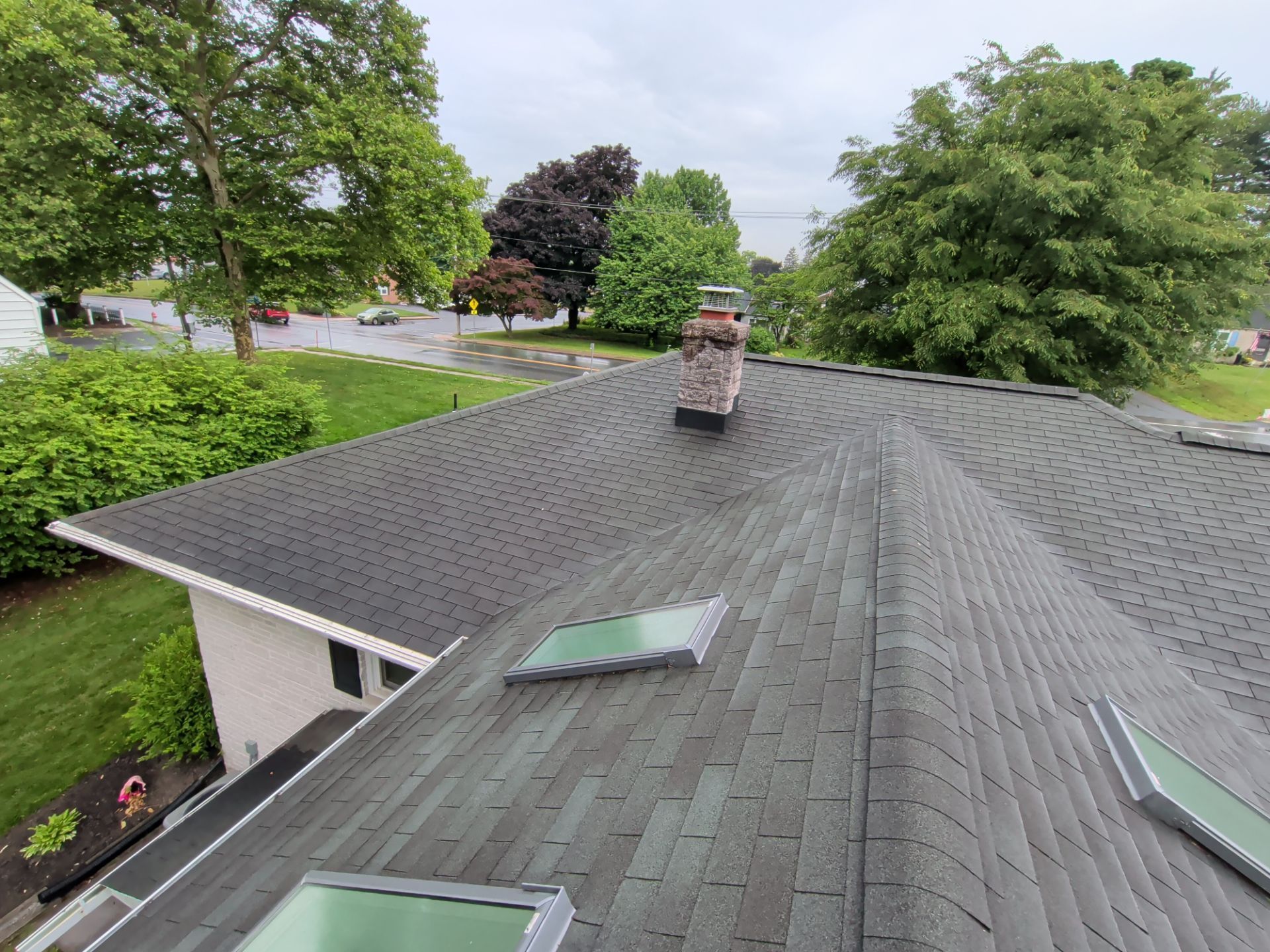 Completed asphalt shingle roof replacement with skylights and chimney flashing upgrades on North Hanover Street in Elizabethtown, PA.