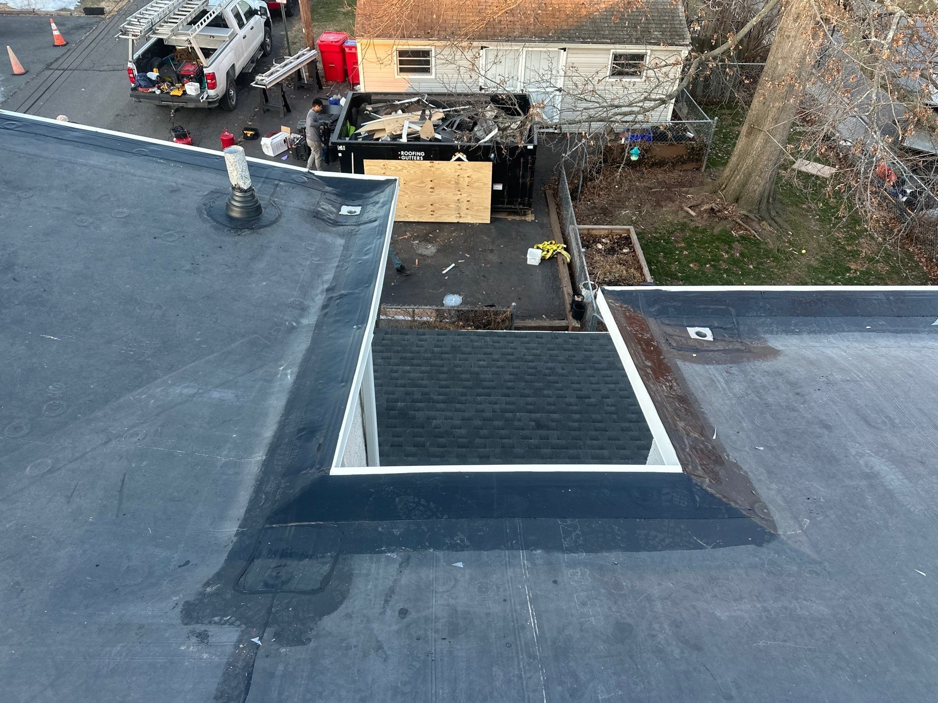 Residential roof replacement in progress with new shingles and roofing membrane on East Vine Street in Pottstown, PA