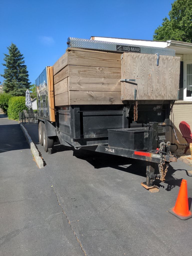 Roof replacement debris container used during a residential roofing project on Forest Avenue