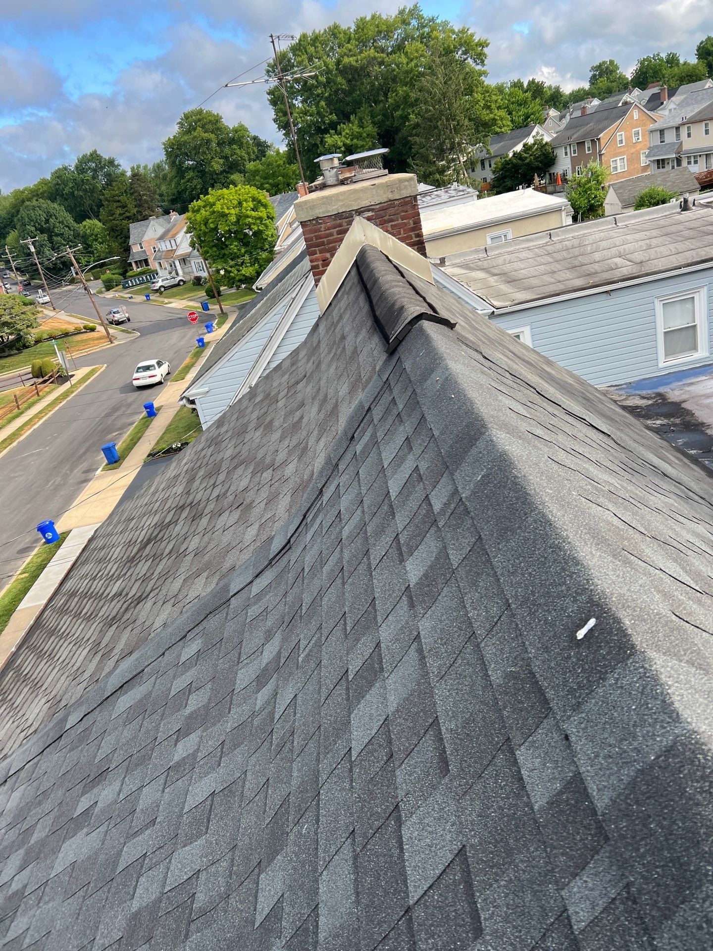 Roof replacement project showing asphalt shingles and ridge detail on Oakford Road in Ardmore, PA