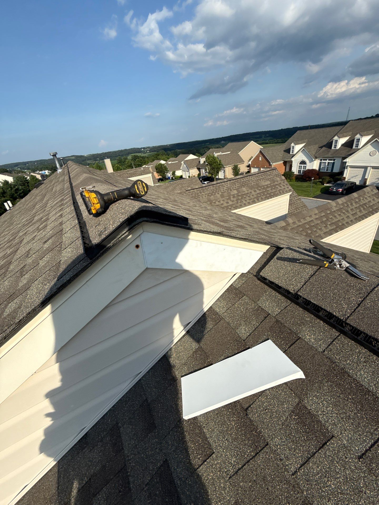 Close-up view of worn and uneven asphalt shingles on a residential roof in York, PA, showing signs of aging and weather-related roofing damage inspected by Joyland Roofing.