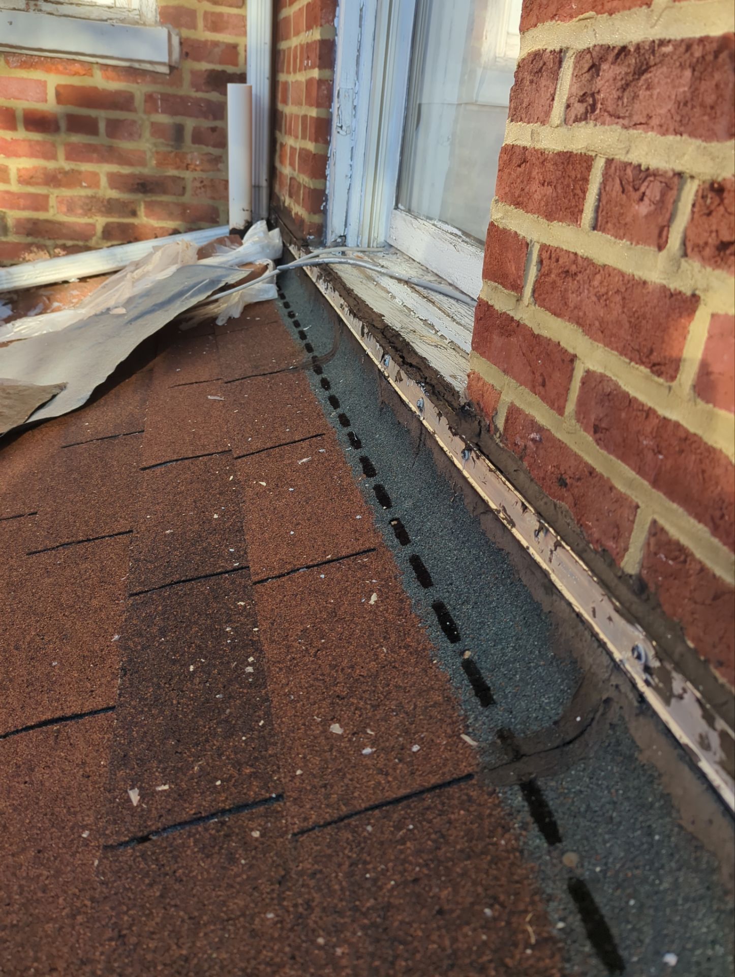 New roof-to-wall flashing installed beneath a window on North Pitt Street in Carlisle, PA.