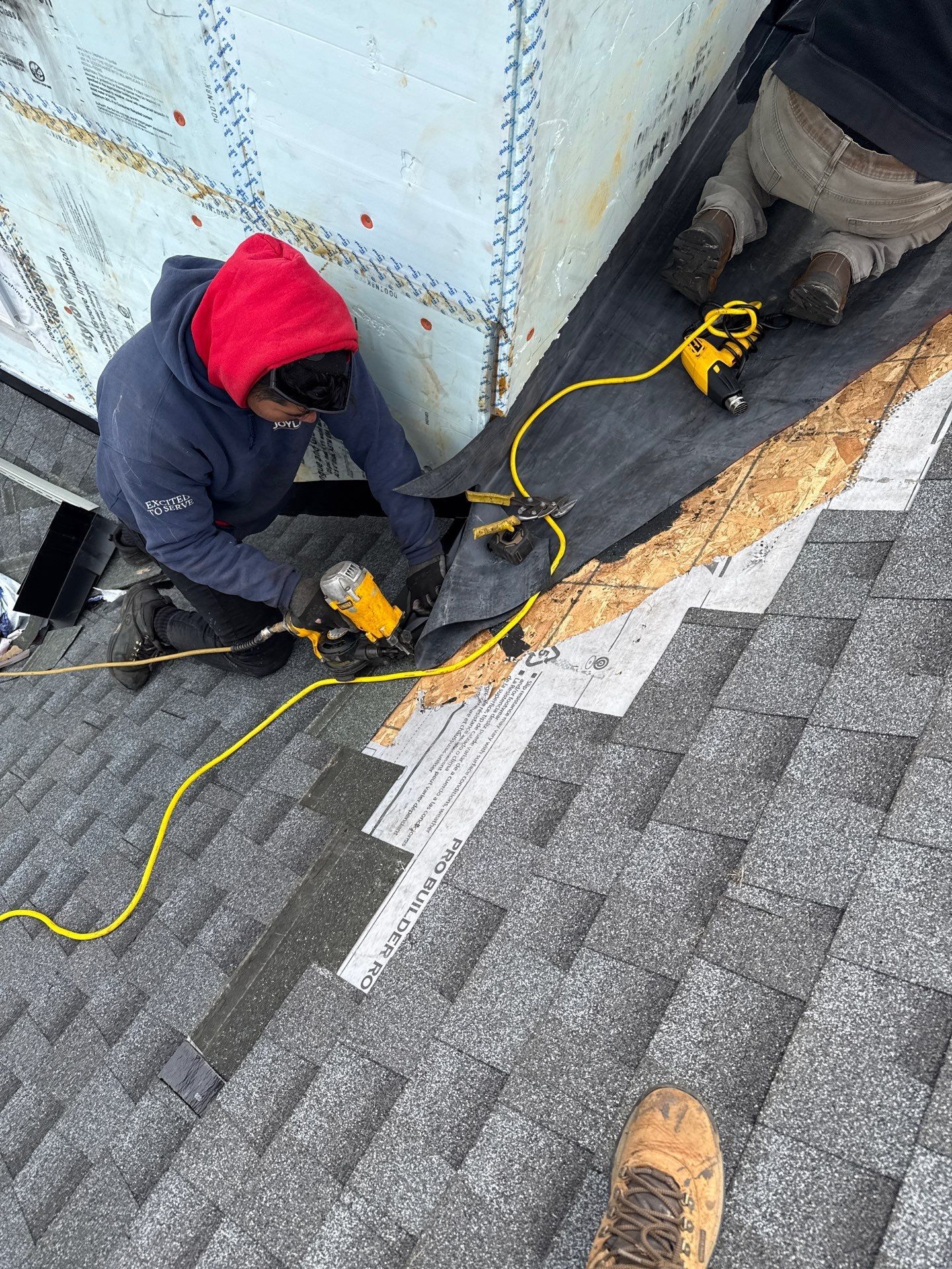 Joyland Roofing crew installing step flashing and waterproof roof-to-wall protection during a roof repair project on Garrison Drive in East Petersburg, PA.