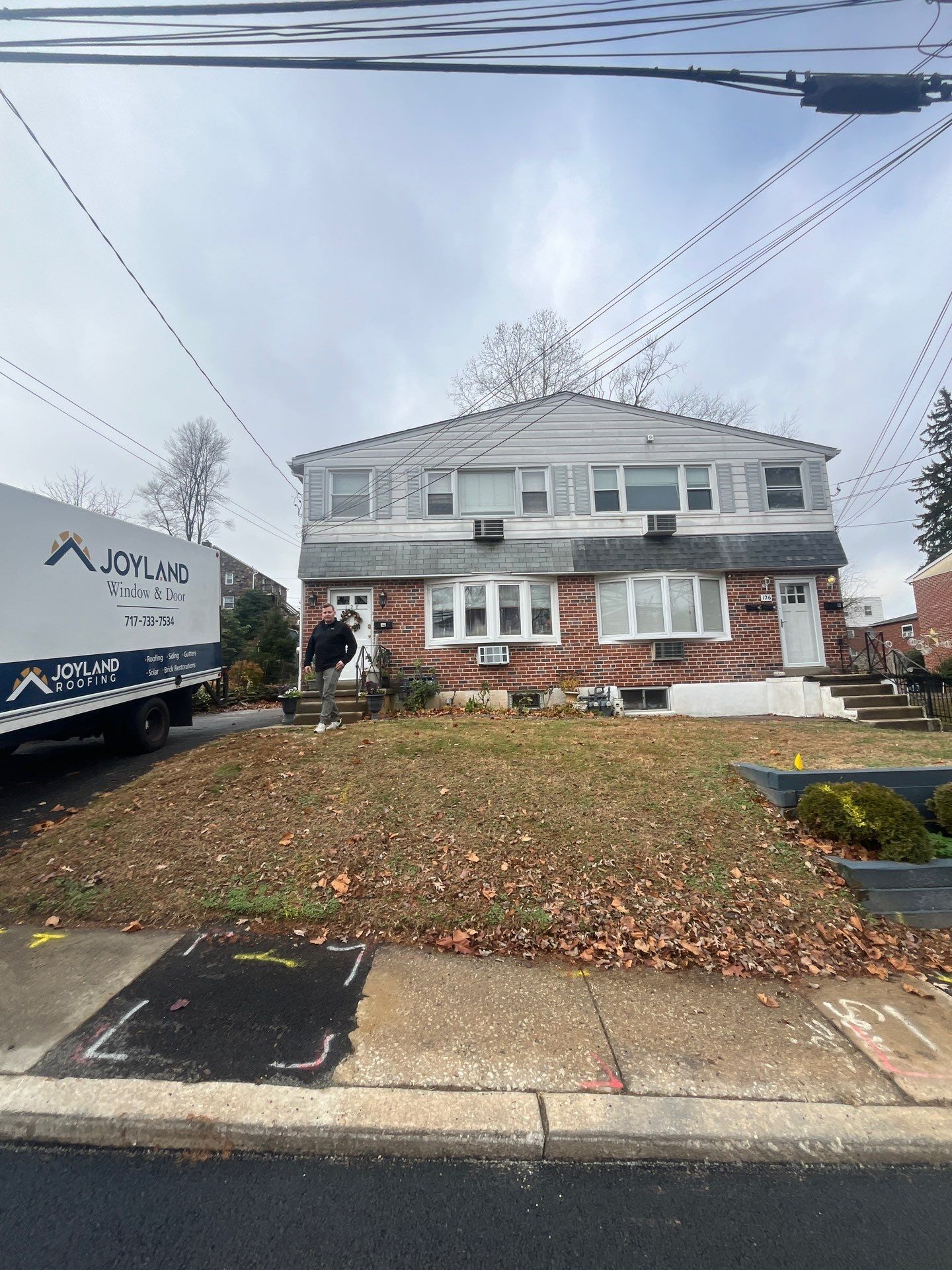 Residential roofing project on Fourth Avenue with Joyland Roofing service vehicle