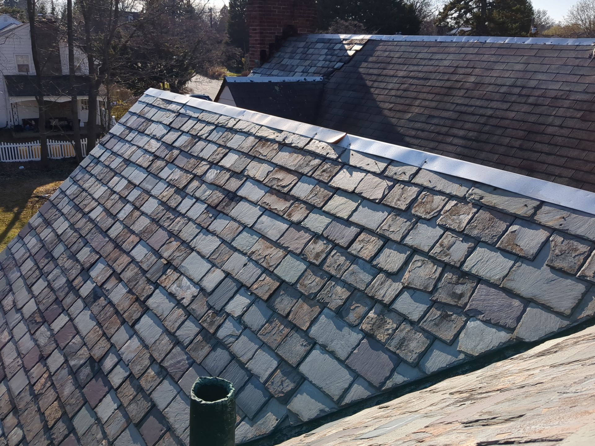 Detailed slate roof repair and ridge flashing on Andover Road in Penn Wynne, PA
