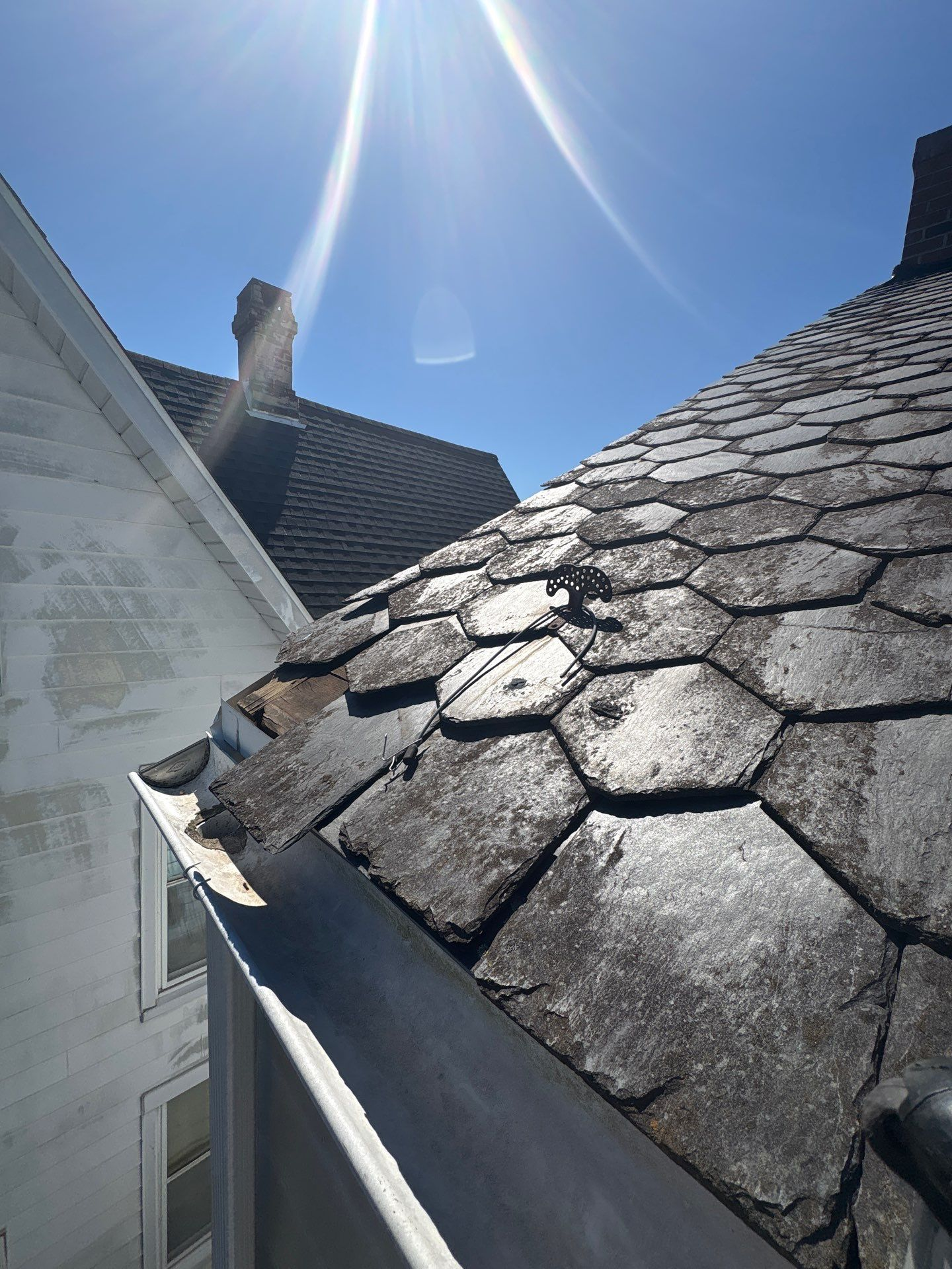 Close-up view of worn and uneven asphalt shingles on a residential roof in York, PA, showing signs of aging and weather-related roofing damage inspected by Joyland Roofing.