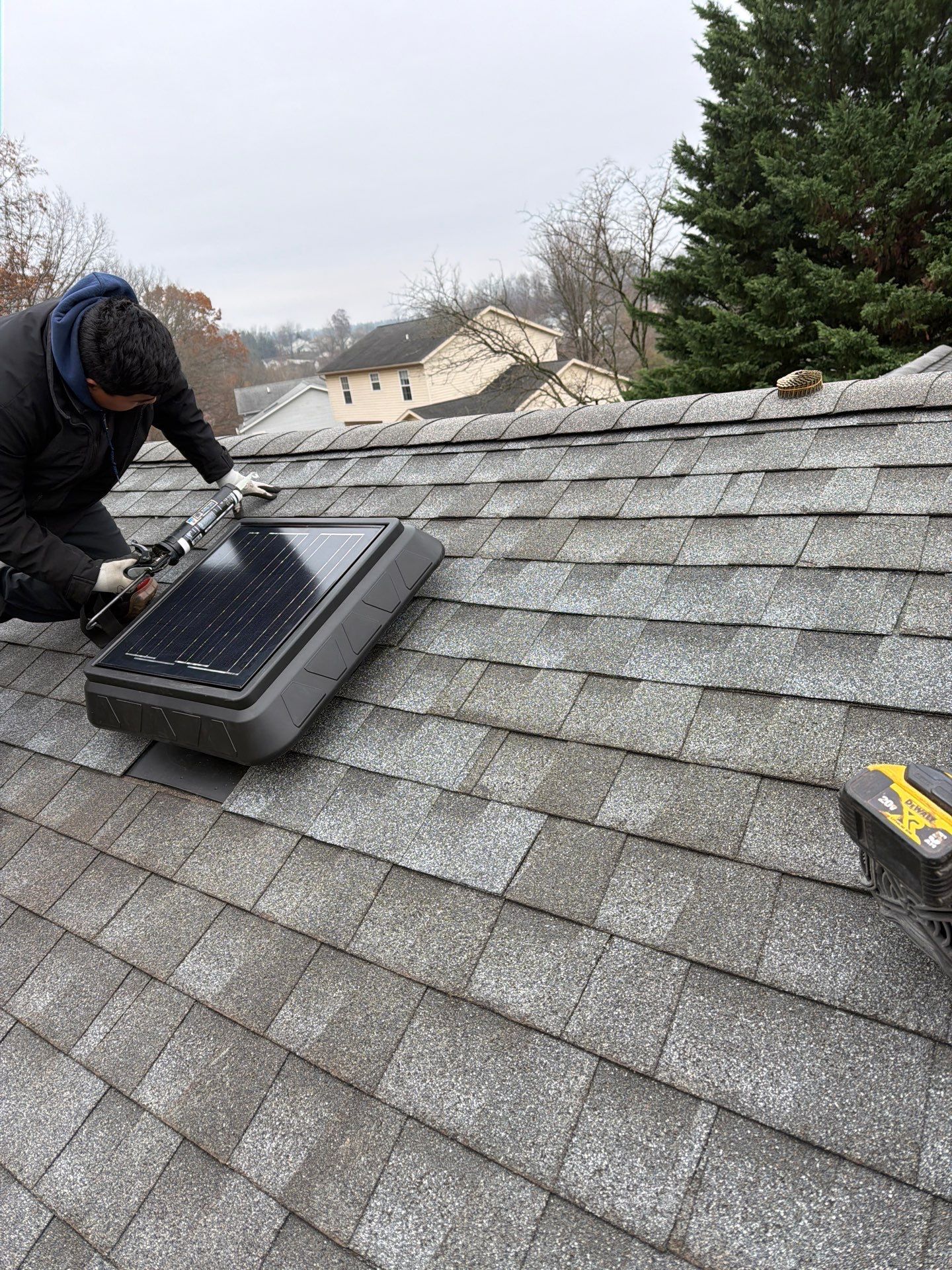 Installing a solar-powered attic fan during a roofing project on Iris Court in Hanover, PA.