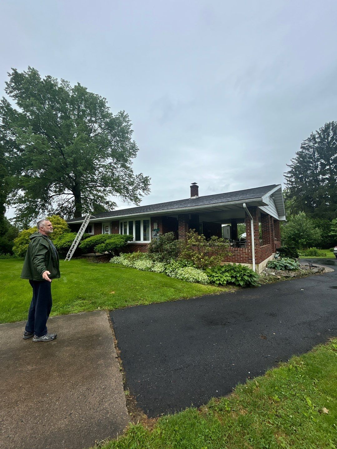 Homeowner discussing a residential roof inspection before an asphalt roof replacement on South Elm Street in Kutztown, PA.
