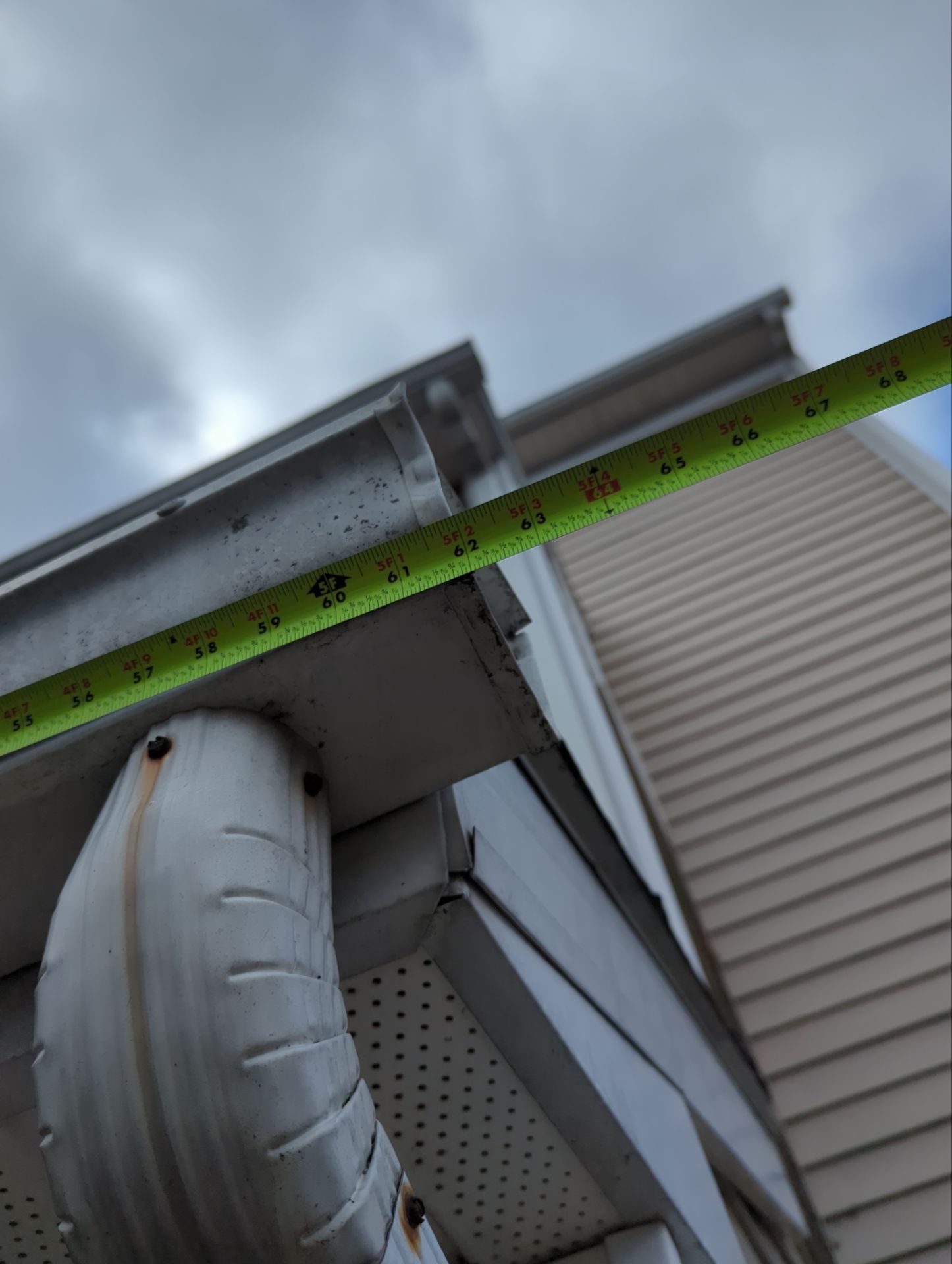Seamless gutter replacement measurement and installation on a home along South Rockford Road in Mountville, PA.