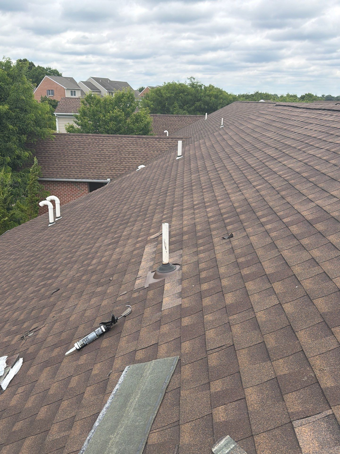 Roof repair in progress around vent pipe flashing on an asphalt shingle roof on South Rockford Road in Mountville, PA.
