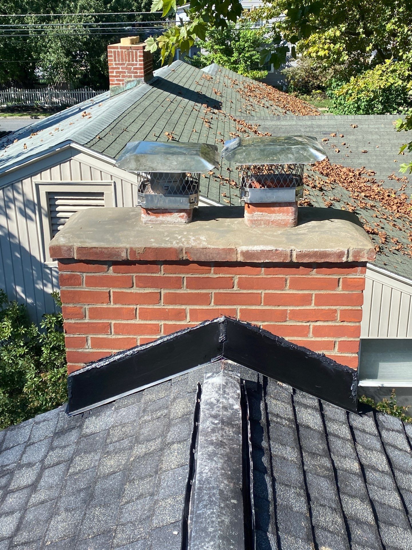 Chimney flashing restoration completed during a roof replacement project on South Stoner Avenue in Shiremanstown, PA by Joyland Roofing.