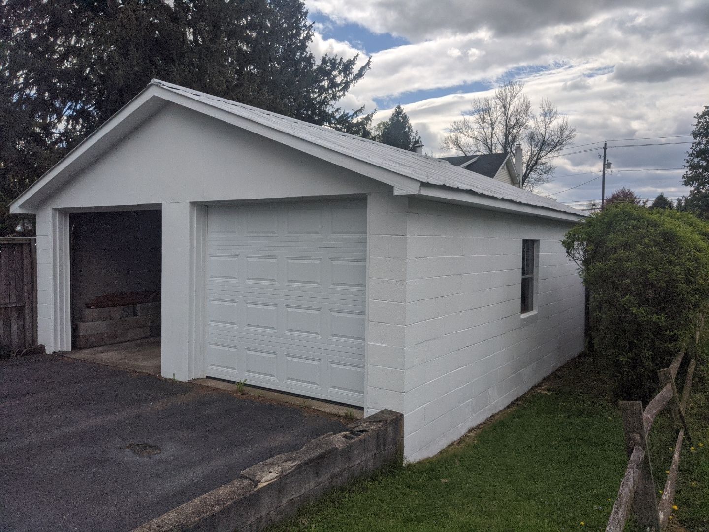 Detached garage with a newly installed asphalt shingle roof on South York Street completed by Joyland Roofing.