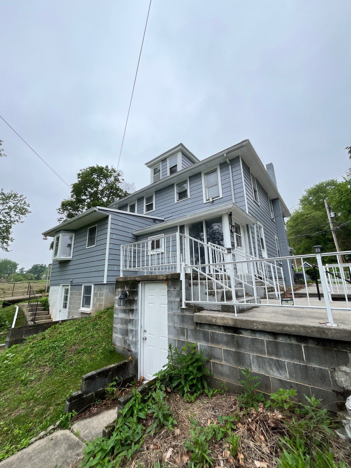 Residential home on Sportsman Road prepared for a complete asphalt shingle roof replacement by Joyland Roofing.