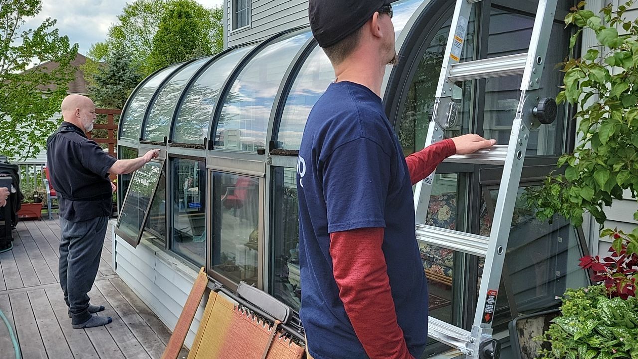 Roofing professionals conducting an exterior inspection at a Spruce Drive home