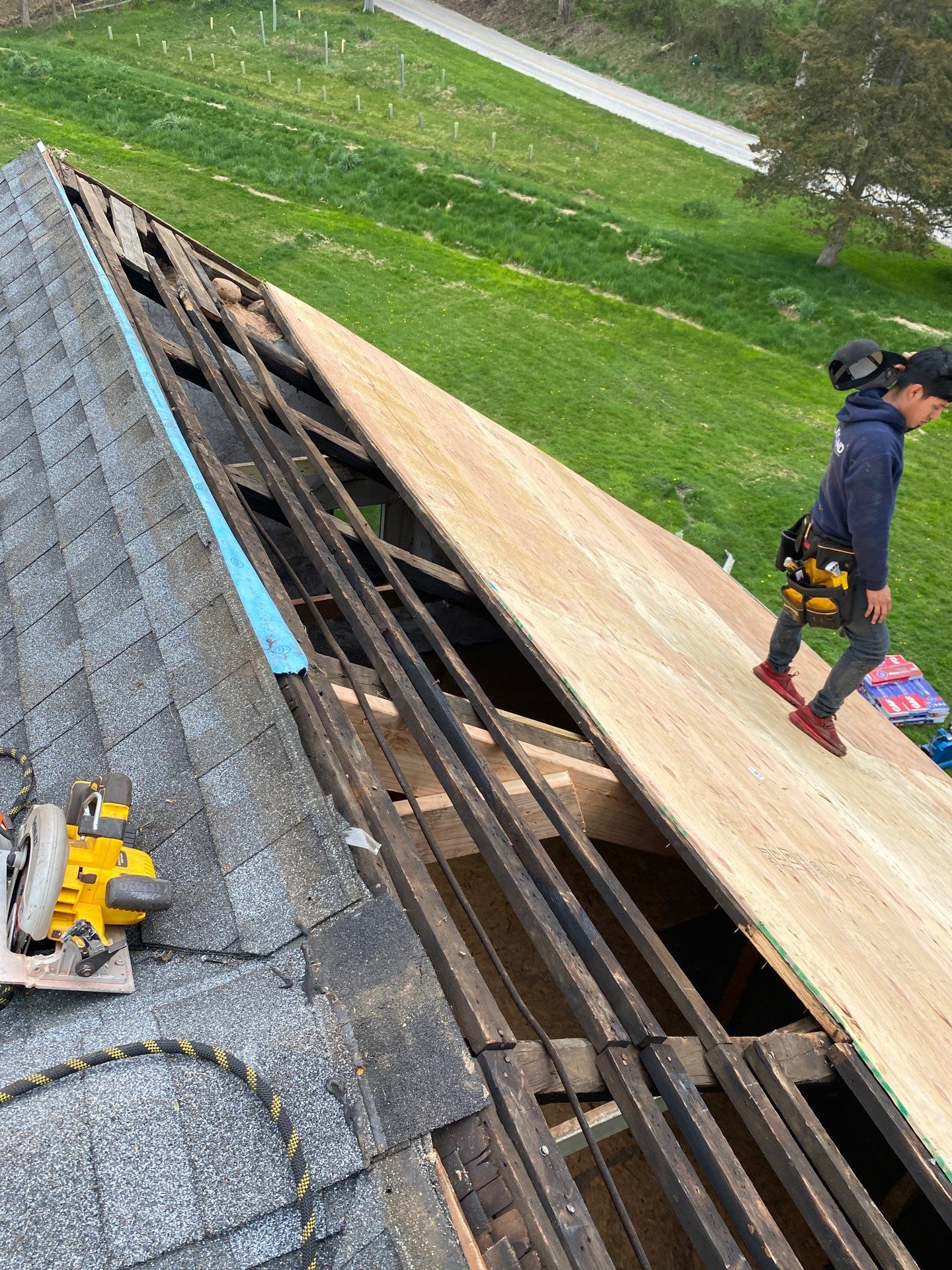 Structural roof replacement in progress with new roof decking installation on Colonial Road in Dover, PA.