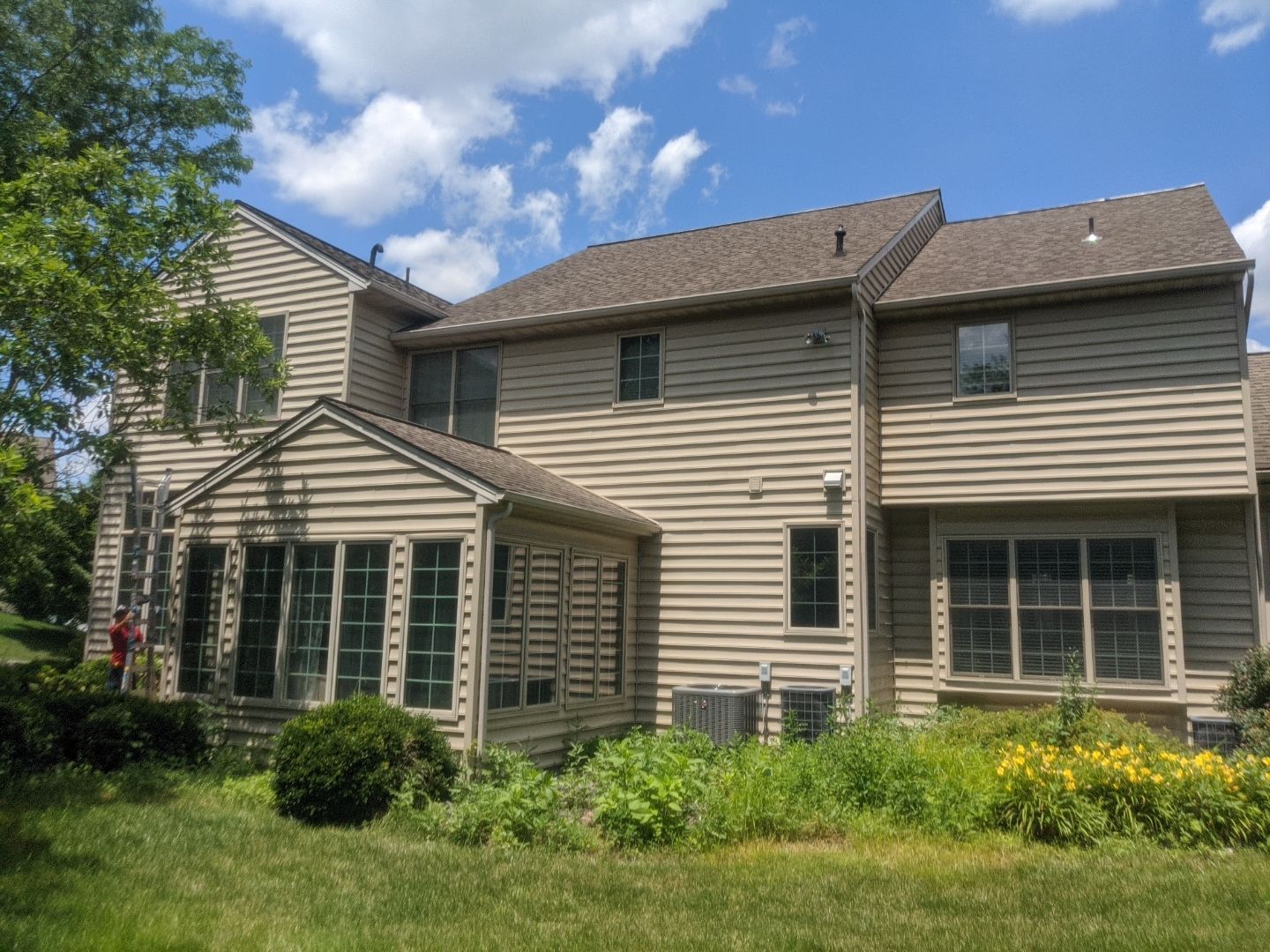 Rear view of a suburban home in York, PA with a completed asphalt shingle roofing project by Joyland Roofing.