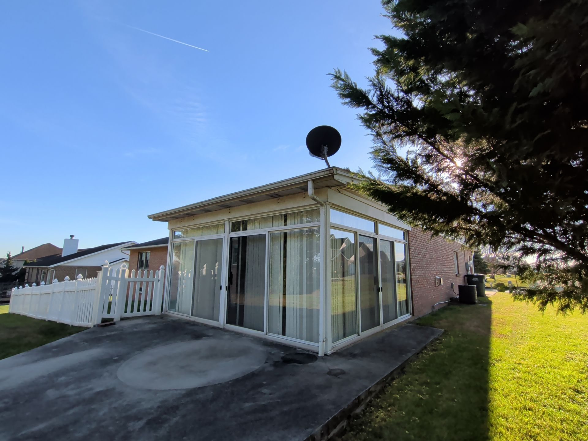 Sunroom roofing project at a home on Country Drive in Dover, PA featuring a low-slope roof and enclosed patio.