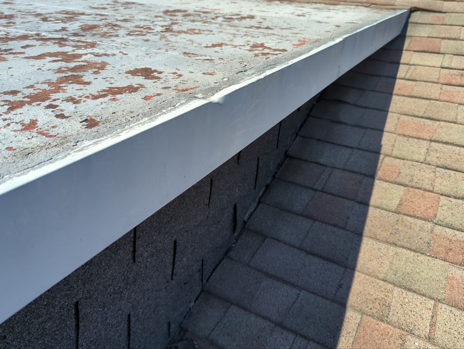 Roof edge flashing and shingle detail from a West Main Street roofing project