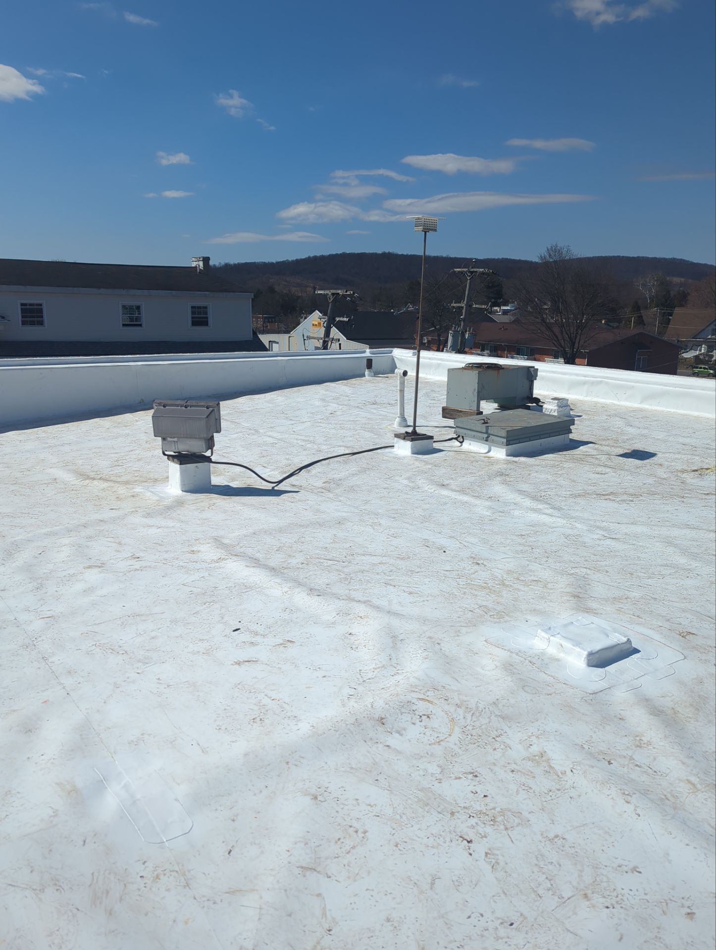 White commercial flat roof with rooftop equipment on West Philadelphia Avenue in Boyertown, PA.