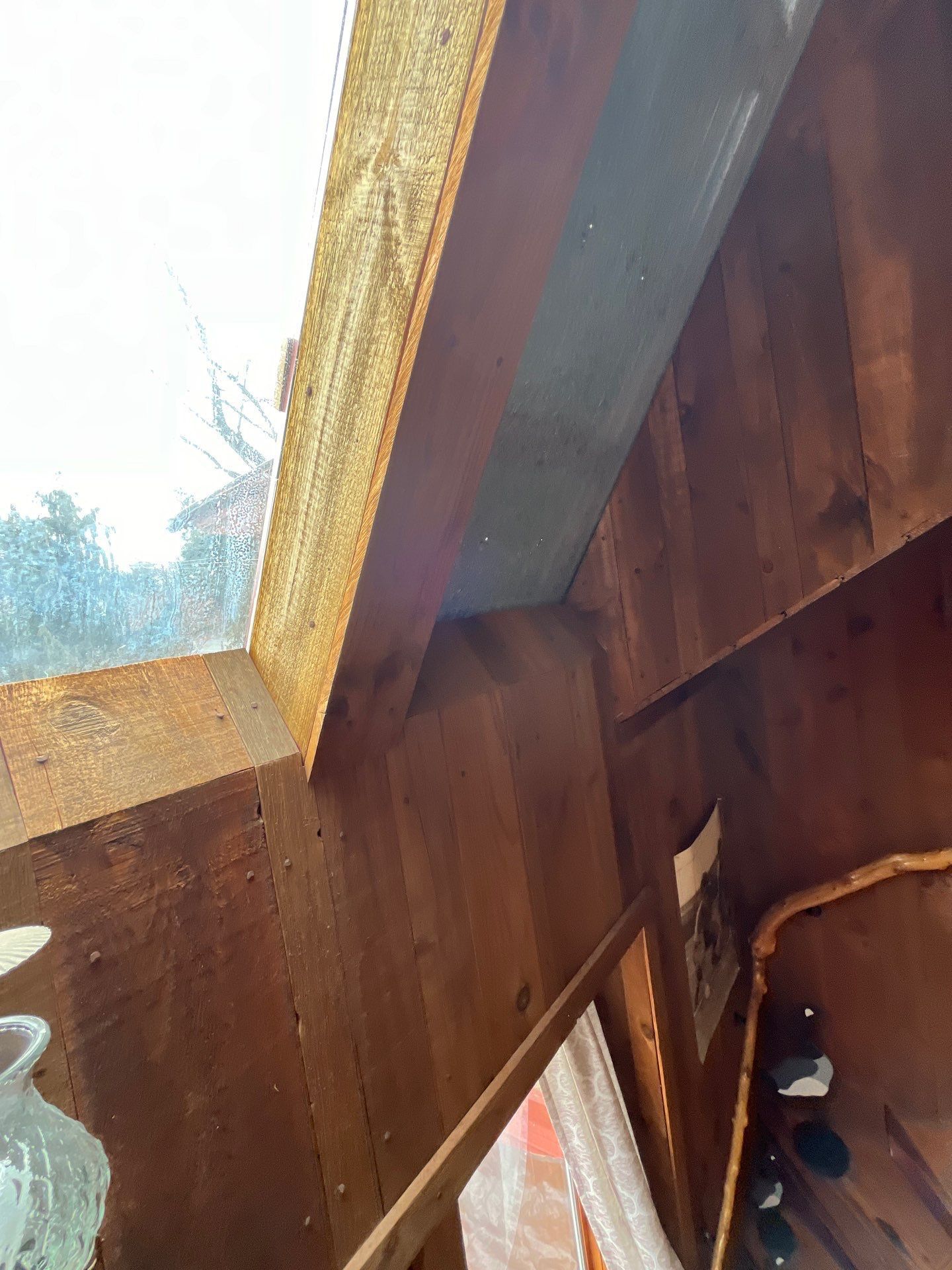 Interior wood framing and skylight area beneath the roof on White Bear Road
