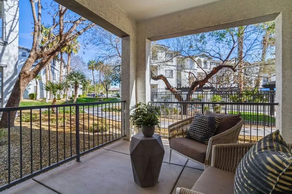 Balcony view of apartment buildings and landscaping.