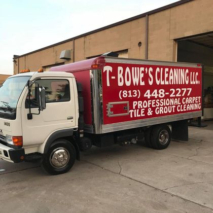 A T-Bowe's cleaning truck is parked in front of a building A T-Bowe's cleaning truck is parked in front of a building