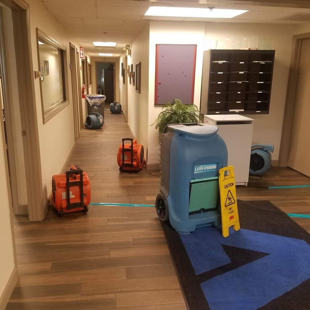 A hallway with a caution sign on the floor