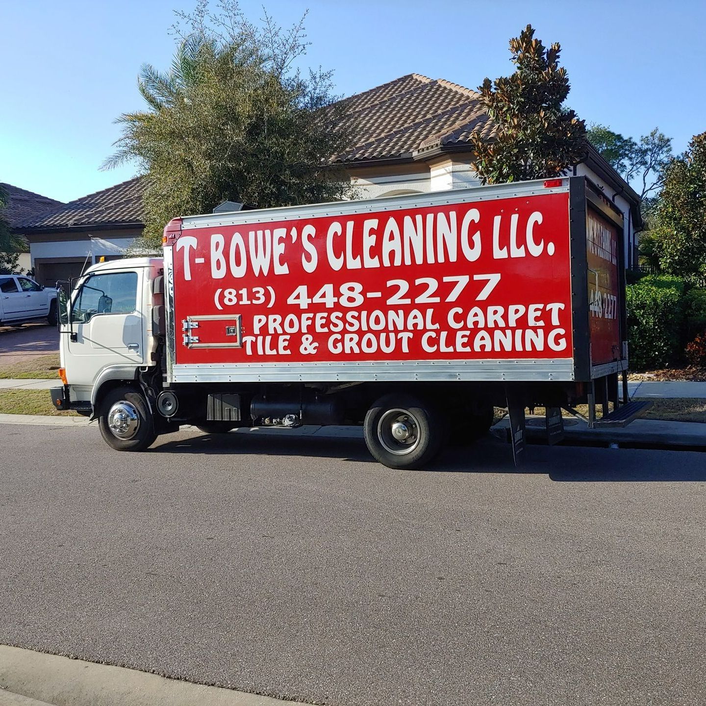 A T-Bowe's Cleaning LLC truck is parked on the side of the road
