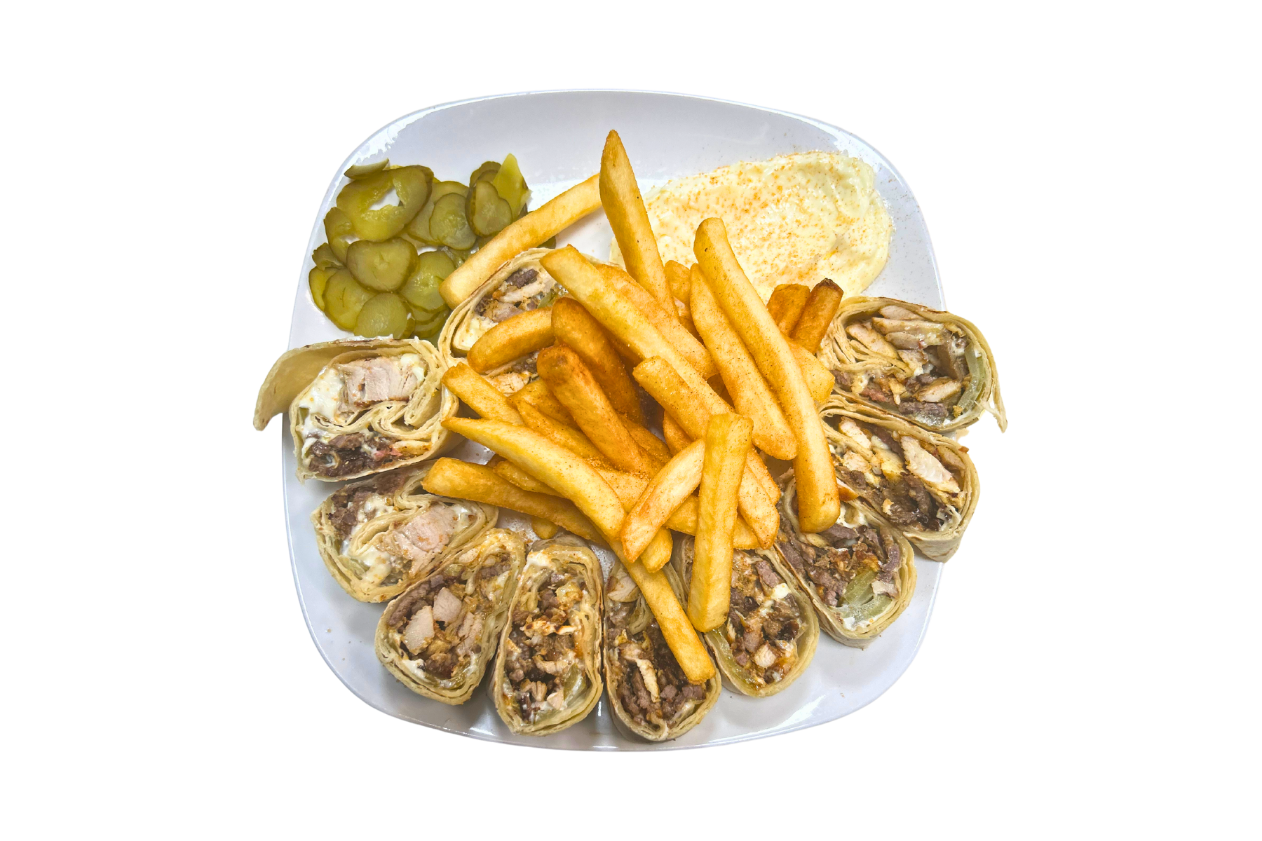 A plate of food with french fries and pickles on a white background.