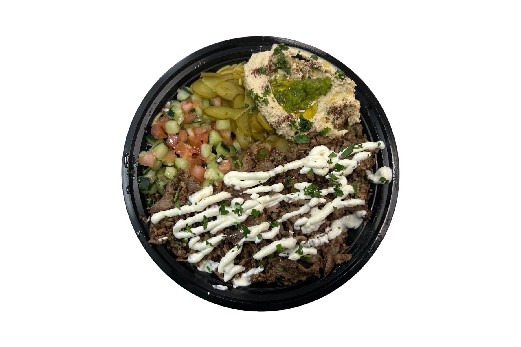 A bowl of food with hummus and vegetables on a white background.