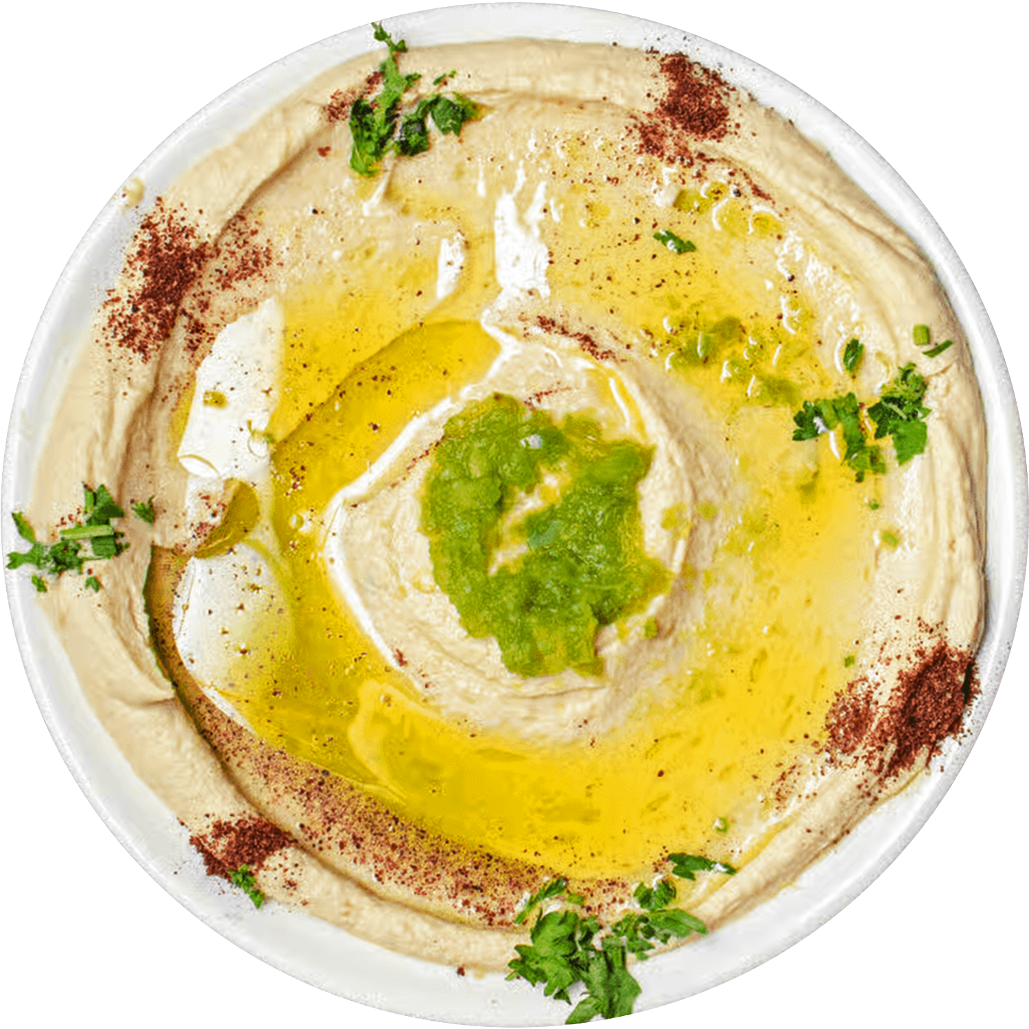 A bowl of hummus with olive oil and parsley on a white plate.