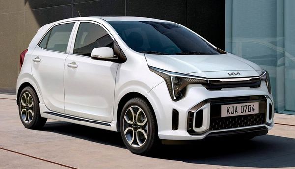 White Kia Picanto parked in front of a building; it has black and yellow details on its wheels.