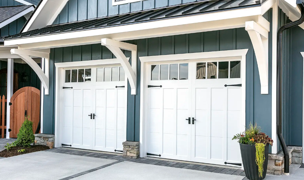 Steel garage door with overlay cladding in white color with windows on top section and decorative hardware in Venice, FL