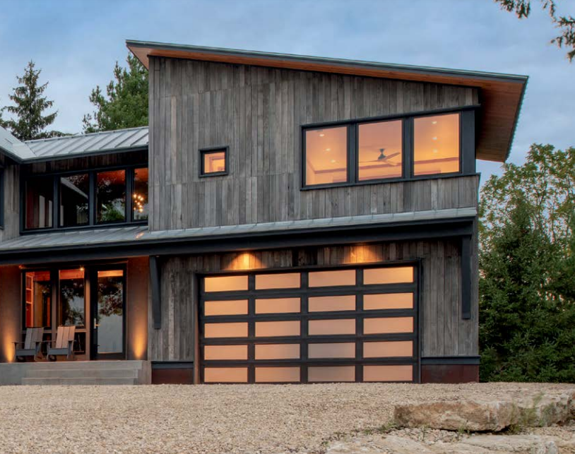 Modern full view steel garage door with all glass rows in color black on a modern new construction home in Venice, FL