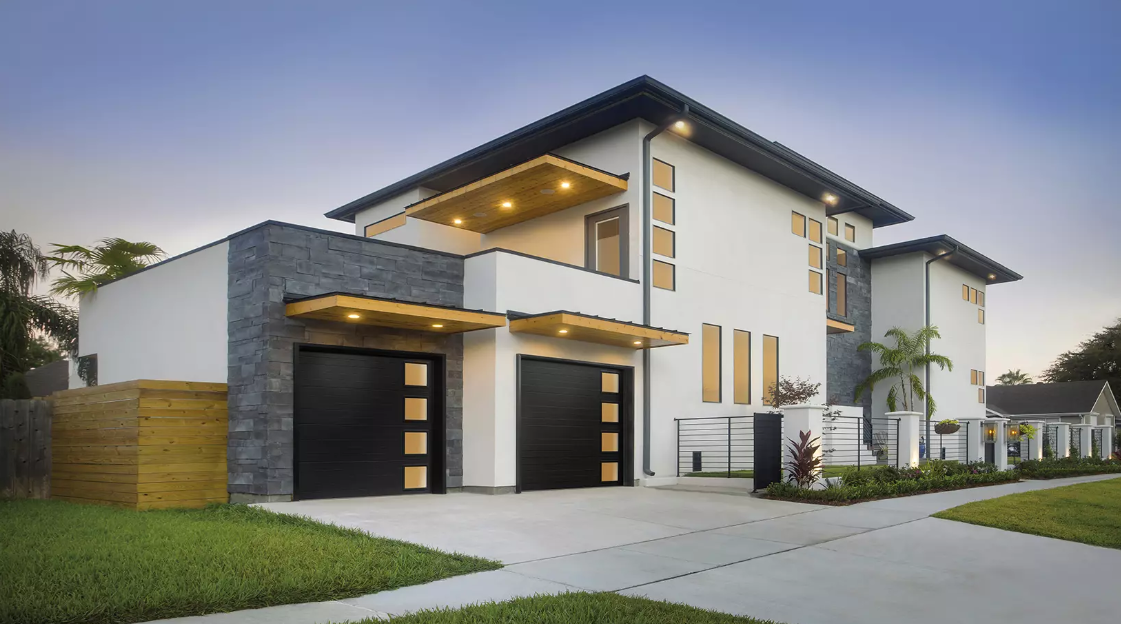Modern steel structured single car garage doors with windows going down one side in Sarasota, FL on a modern house