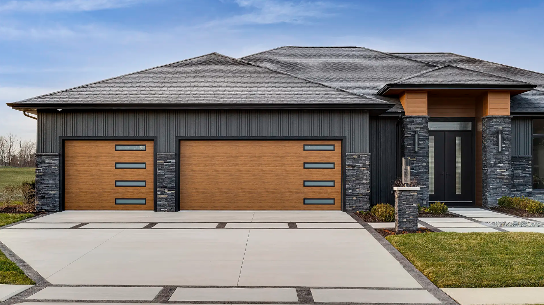 Steel garage door with modern aesthetic in a medium oak wood look and frosted slim windows going down one side