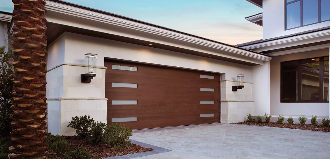 Modern glass garage door with wood cladding overlay in mahogany finish plank design in Sarasota, FL