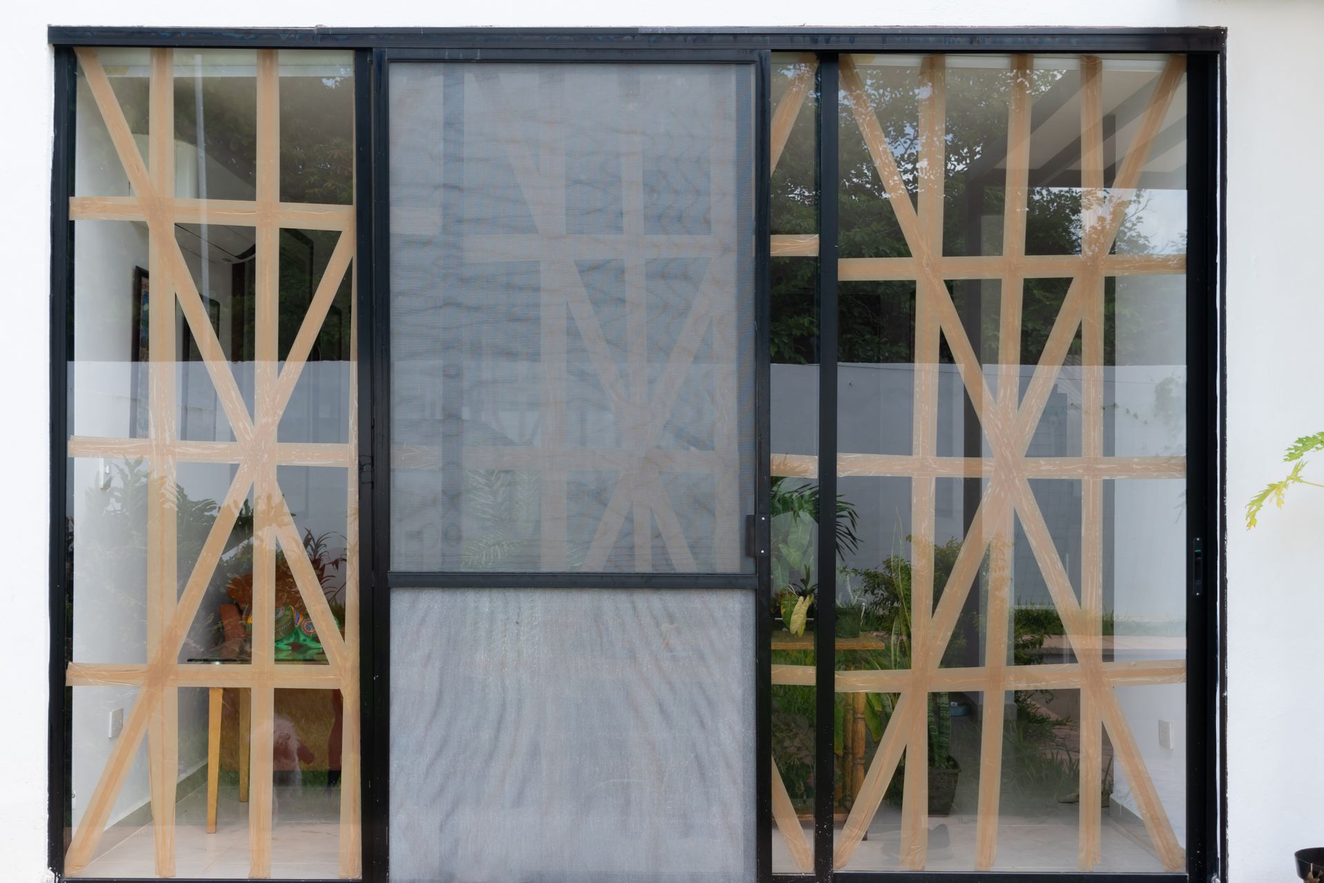 Modern glass storefront with wooden cross-bracing and a central door