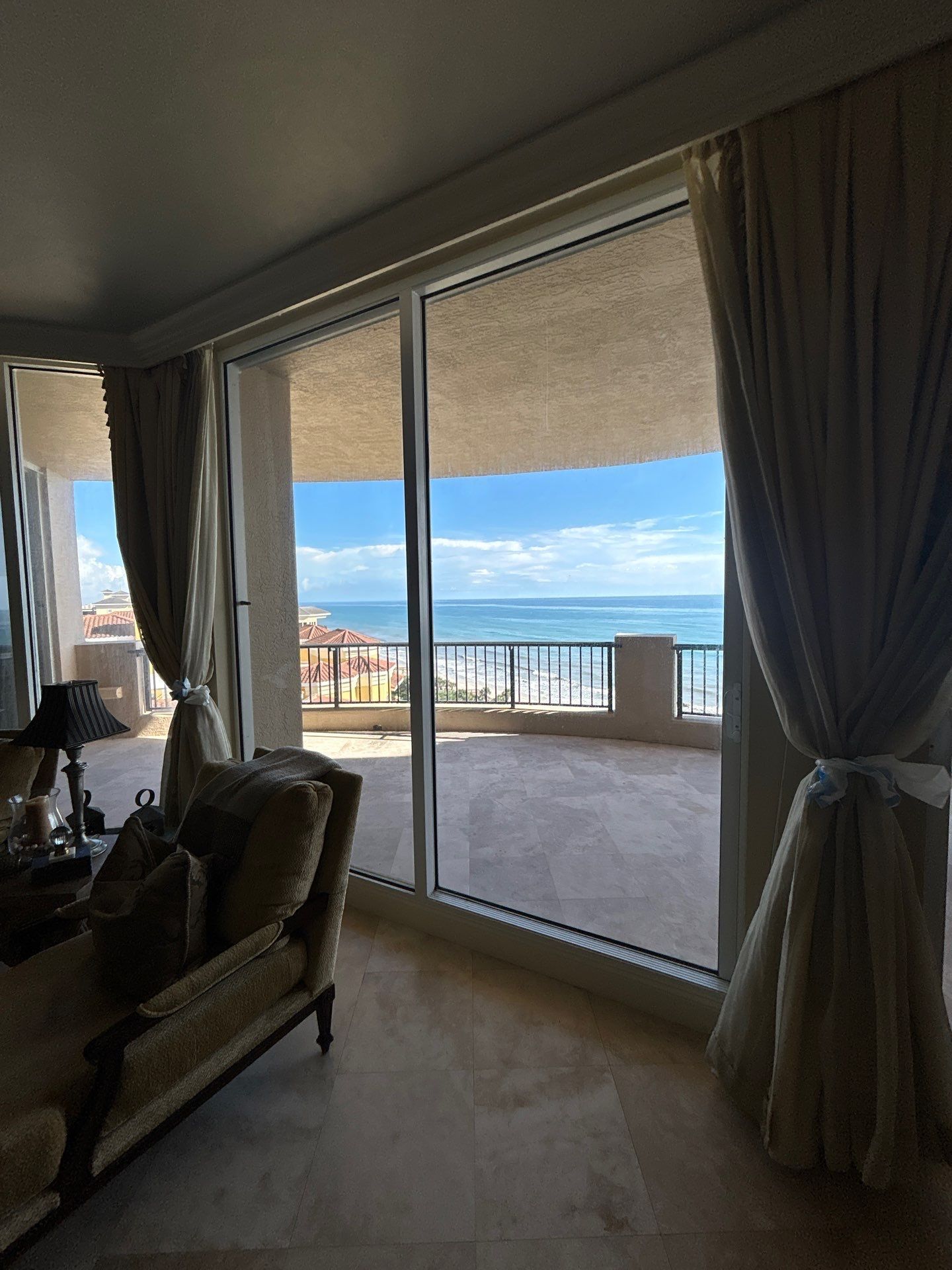 Sliding glass door opening onto a balcony at a coastal condominium.
