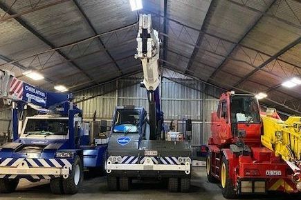 A Group of Cranes Are Parked in a Warehouse — CA Crane Hire in Forest Glen, QLD